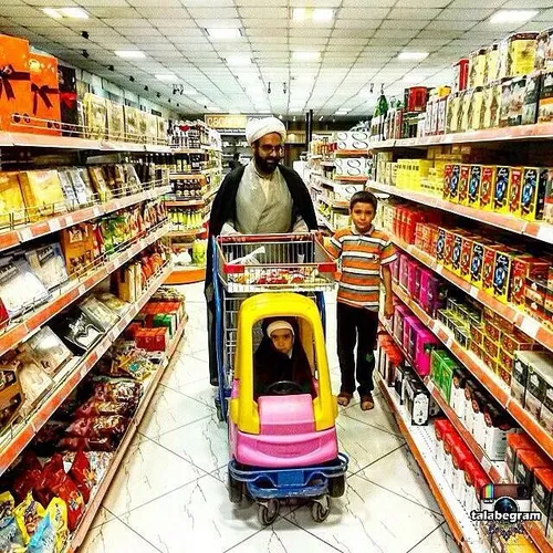 A Muslim clergyman shops around Qom Hypermarket, along wi