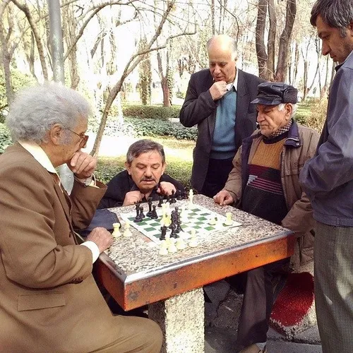Elderly men playing chess in Hasht-Behesht Park. Isfahan,