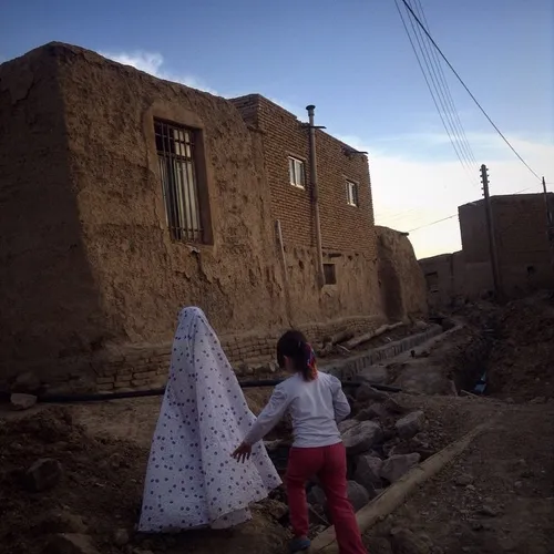 Two girls walking through Pordoul village, few kilometers