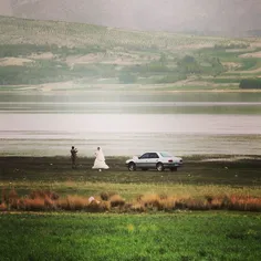 A bride and groom take a photo by Choqakhor Wetland. #Bor