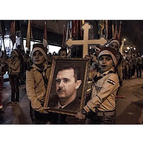 Children hold a portrait of Syrian President Bashar al-As