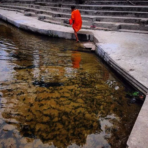 A holy man gets ready to wash his cloths on the bank of B