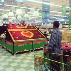 A shopper takes a photo of a Valentine's Day display made