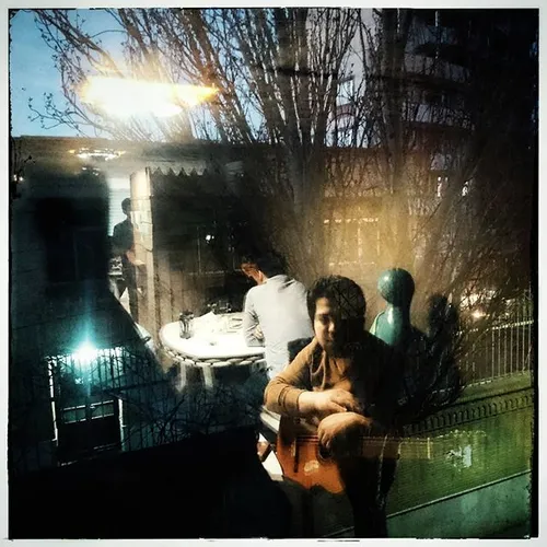 A guitar player in a café in Tabriz , Azerbaijan Province