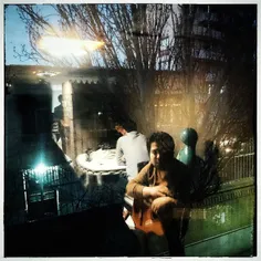 A guitar player in a café in Tabriz , Azerbaijan Province