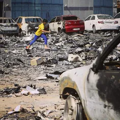 A young boy runs through debris from a high rise fire in 