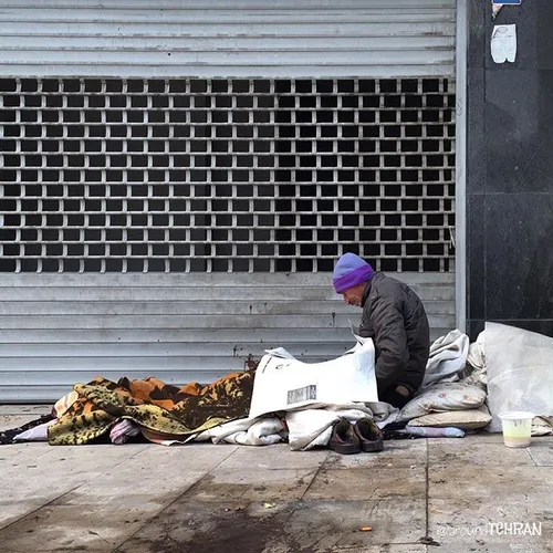 Homeless man is reading morning paper at minus 1. reading