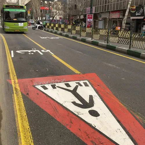 A bus is approaching the zebra crossing on a BRT lane. | 