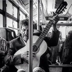 A man plays the guitar in a public bus. #Tehran, #Iran. P