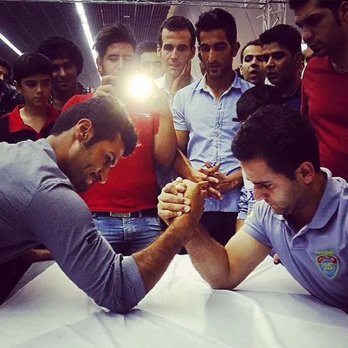 Arm-wrestling completion in a subway station. Tehran, Ira