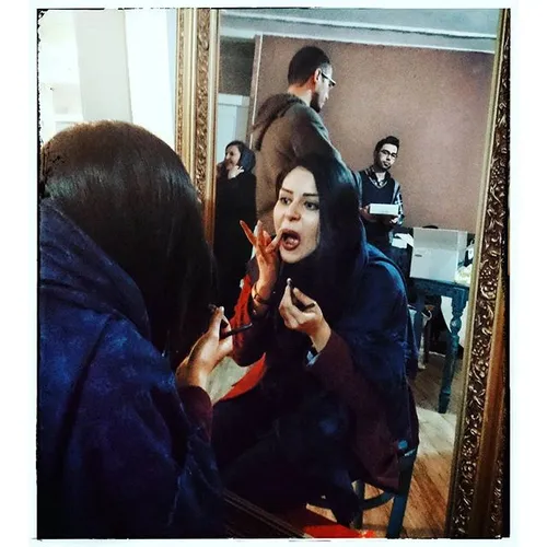 A girl renewing her make up in a studio in Tabriz , Azerb