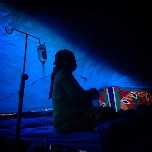 A Nepalese patient eat her breakfast as she stays inside 