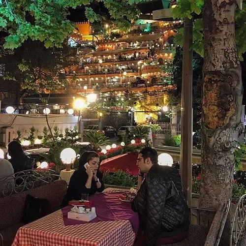 A couple at a restaurant in Darband, the beginning of a v