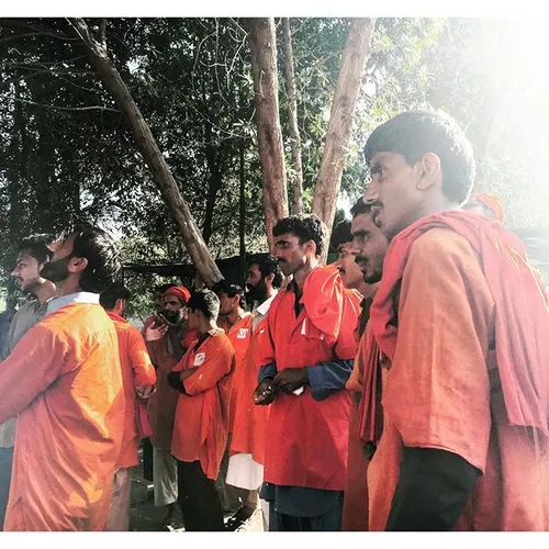 Several "Coolies" (train porters) gather outside the stat