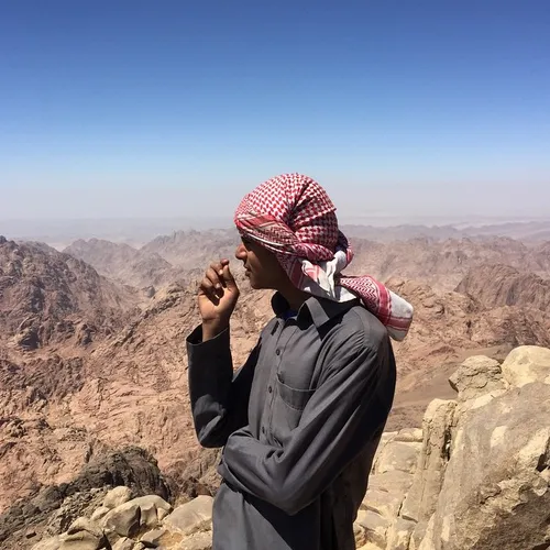 A tourist guide stands in the top of Mount Katherine in t