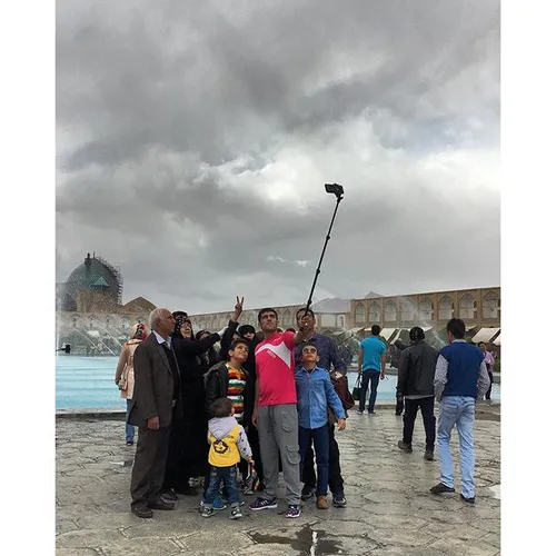 Changeable weather in Isfahan today. A family are taking 