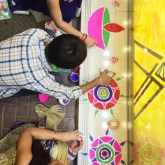 Hindu children create patterns using various materials, a