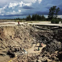 Illegal miners works at abandoned tin mine in Bangka Isla