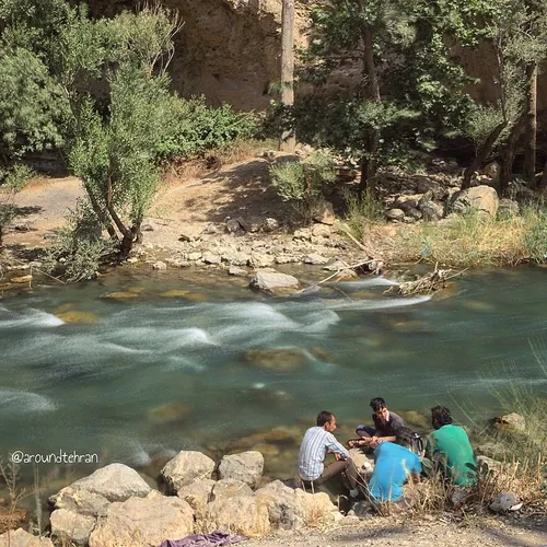 Blokes are having a picnic on the river bank, near Tehran