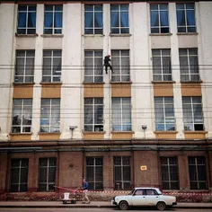 Construction workers repair a building in center of Ufa. 