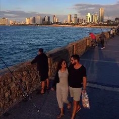 A couple enjoy the sunset at #Jaffa beach. iPhone photo b