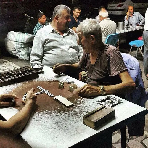 Men get together at a chaykhaneh (tea house) at night. Ba