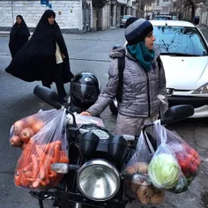 A woman waits for her husband after a grocery shopping sp