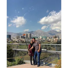 A young couple are taking selfies on the Tabiat bridge. |