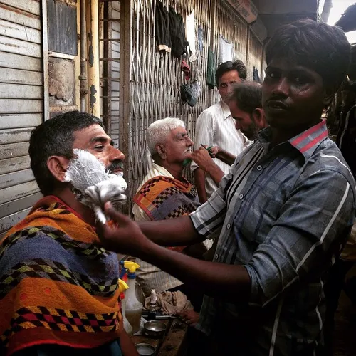 Men at the Chor Bazaar get a close shave on the side of t