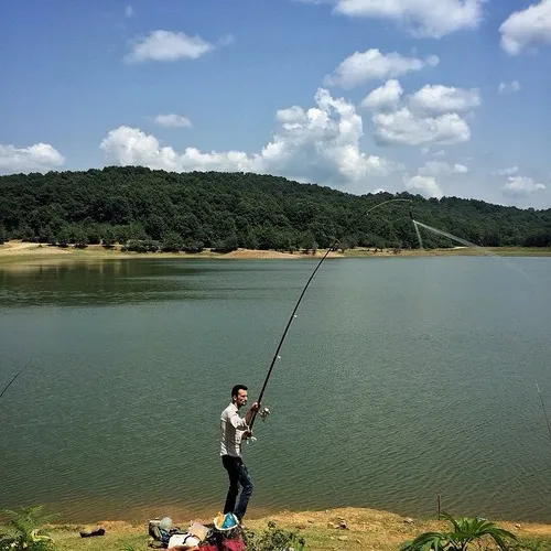 A man hooking in the lake of Saqalksar Dam. Rasht, Gilan,