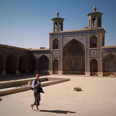 A tourist at the courtyard of Nasir-al-Molk Mosque (known