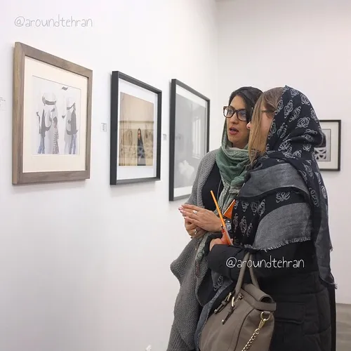 Women looking at a work by late Sadegh Tirafkan at the Sh