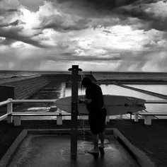 Daily life at the Newcastle Ocean Baths: A surfer takes a