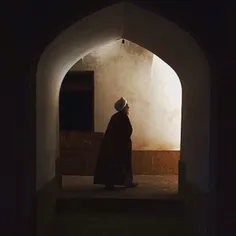 A Muslim clergy walks through a corridor in Khan School, 