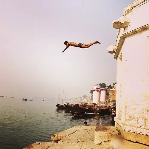 A man jumps to take holy bath at river Ganga . Varanasi I