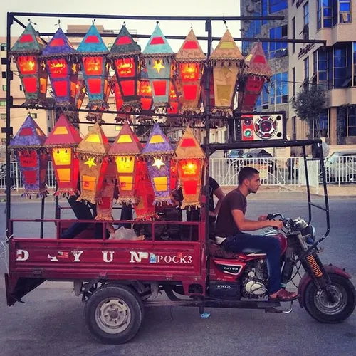 A Palestinian vendor selling Ramadan lanterns on a tuk-tu