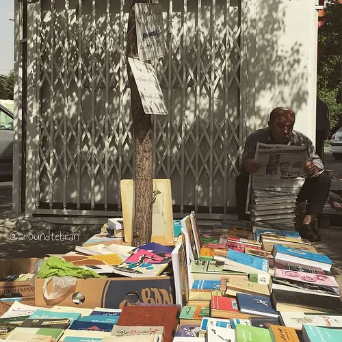 A book vendor is reading the papers | 24 May '15 | iPhone