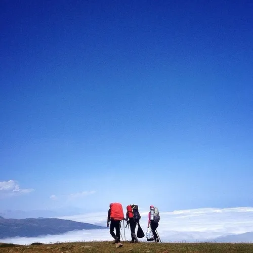 Hikers walk along a cloudy valley at Mazichal Village. In