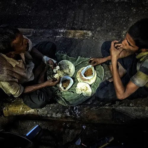 An Indian Muslim father and son break their fast as they 