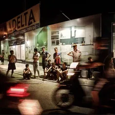 Young workers take a break and enjoy night street scene i