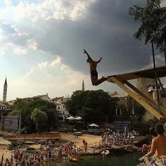 Young local boys jumping off the 9m podium into Neretva r