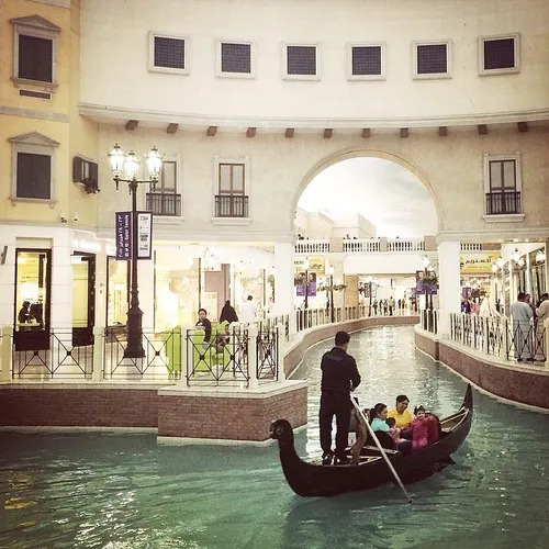 A family ride in a gondola in a Venetian-style lagoon at 