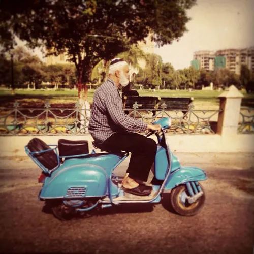 An elderly man seen riding a Vespa on the streets of Kara