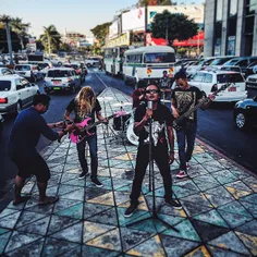A local rock band films a music video on Sule Pagoda road