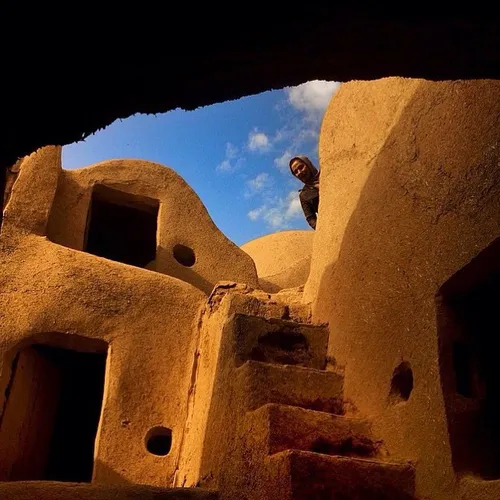 A visitor at Mehr-jard Castle, an old structure remained 