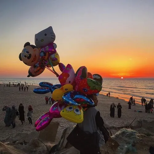 A Palestinian man sells balloons in the Gaza Port. iPhone