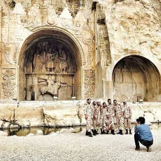 A group of draftees have their photo taken in front of Ta