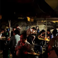 Street-side dining, Hong Kong-style. At the foot of uber-