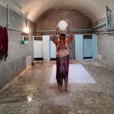 A man takes a bath at a nearly 100-year-old public bathho