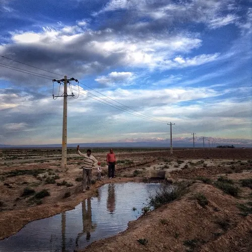 Villagers siphon water from a electronic tube well a few 